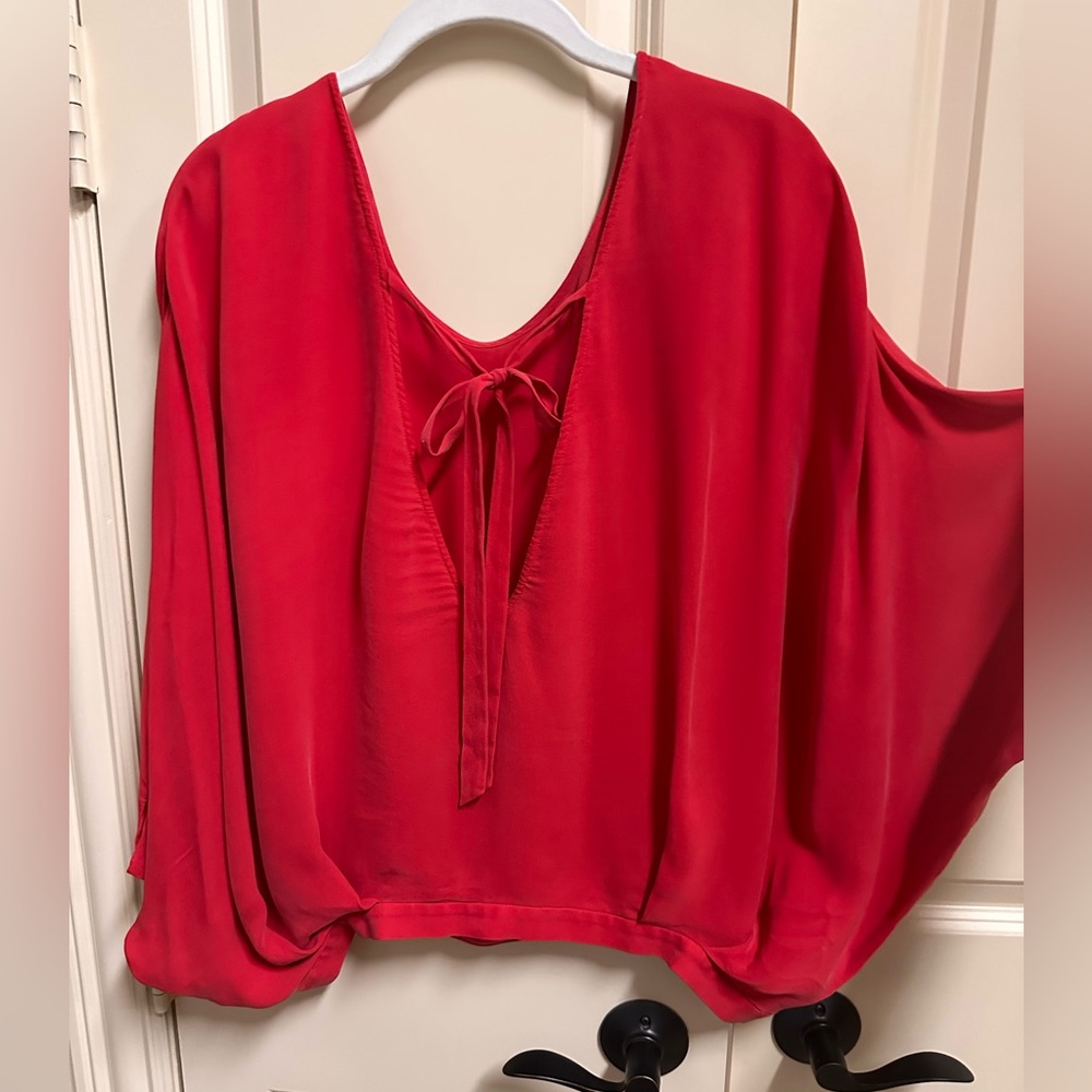 Alice and Olivia silk blouse button side closure at waist. Open back with tie